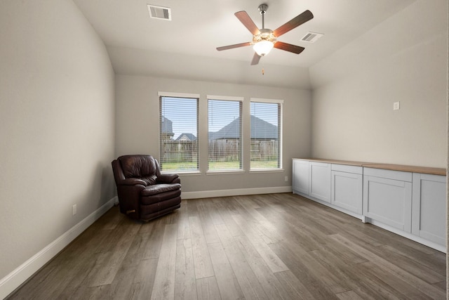 unfurnished room with vaulted ceiling, ceiling fan, and light wood-type flooring