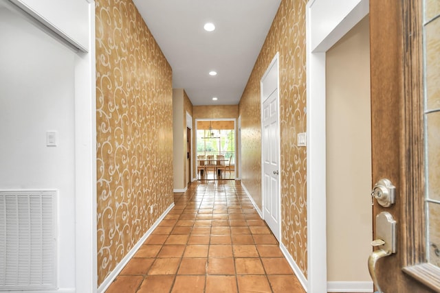 hall featuring light tile patterned floors