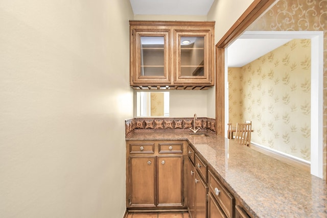 bar with sink and stone countertops