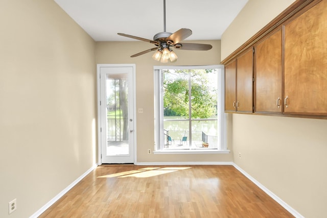 doorway featuring ceiling fan and light wood-type flooring