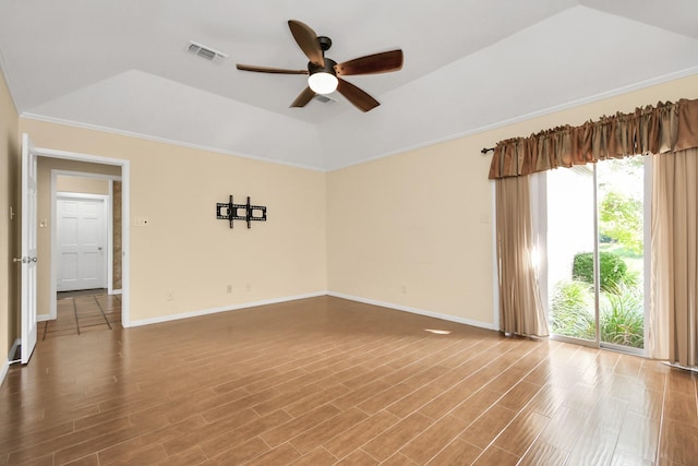 unfurnished room with lofted ceiling, wood-type flooring, a raised ceiling, and ceiling fan