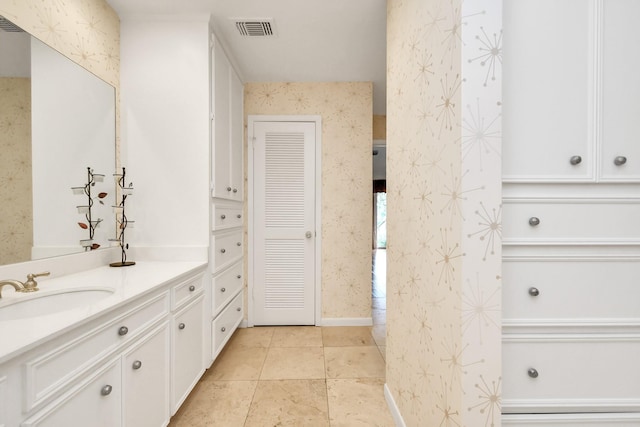 bathroom featuring tile patterned flooring and vanity