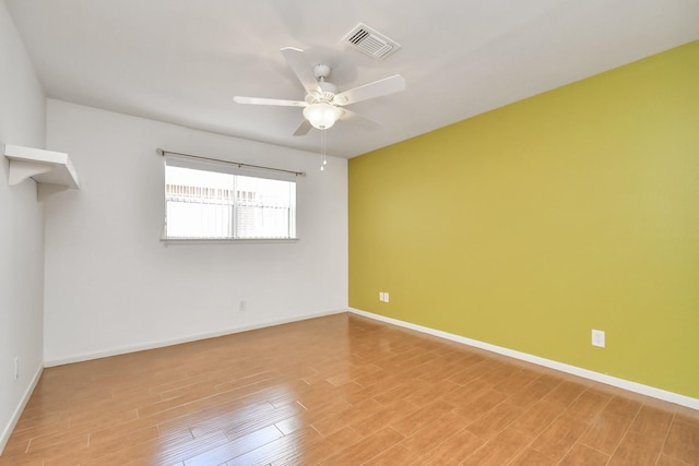 unfurnished room with ceiling fan and hardwood / wood-style floors