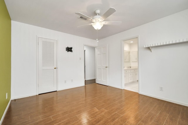 empty room featuring wood-type flooring and ceiling fan