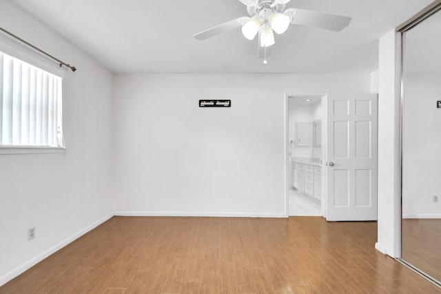 spare room featuring wood-type flooring and ceiling fan