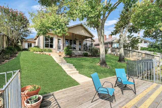 deck with ceiling fan and a lawn