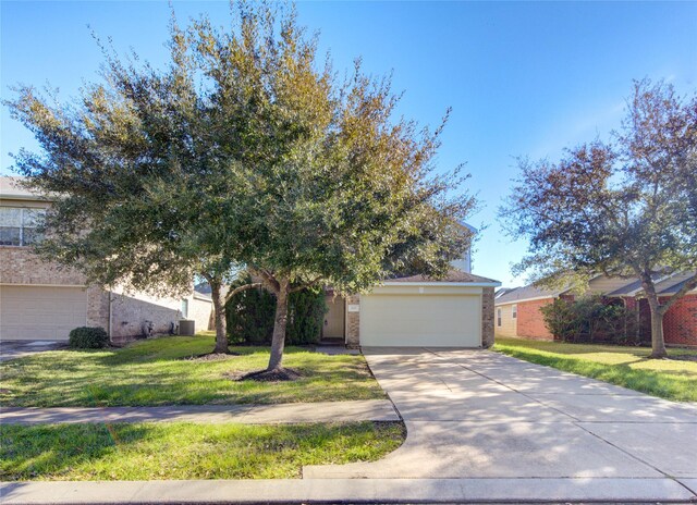 view of front of property featuring a garage and a front lawn