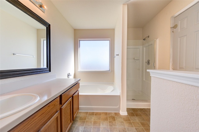 bathroom featuring plus walk in shower and vanity