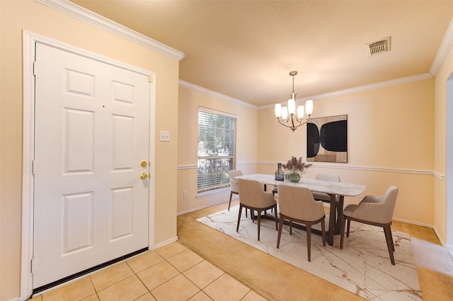 dining space with ornamental molding, light colored carpet, and a notable chandelier