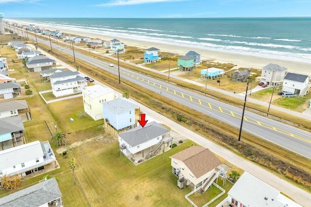 drone / aerial view featuring a beach view and a water view