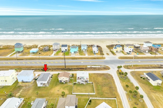 birds eye view of property featuring a water view and a view of the beach