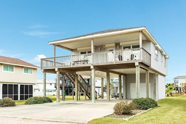 back of property featuring a carport, a garage, a porch, and a lawn