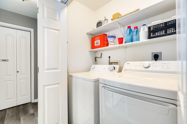 clothes washing area featuring dark hardwood / wood-style flooring and washer and dryer