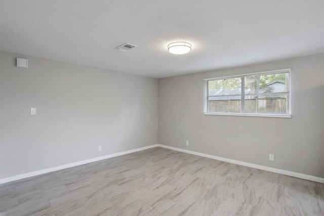 unfurnished room featuring a textured ceiling