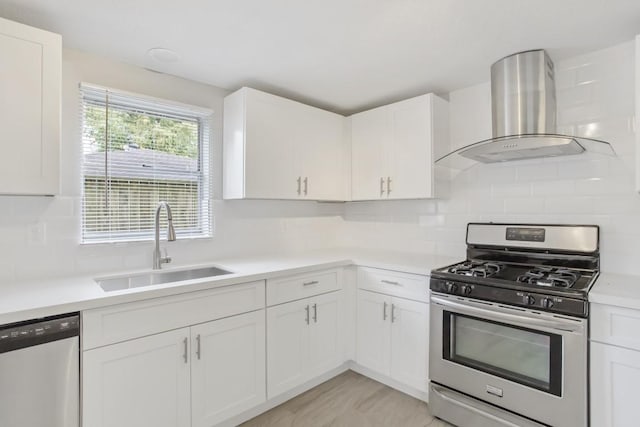 3114 Carolyn St, Bacliff, TX 77518 - kitchen with stainless steel gas range, wall chimney range hood, dishwashing machine, a sink, and light countertops
