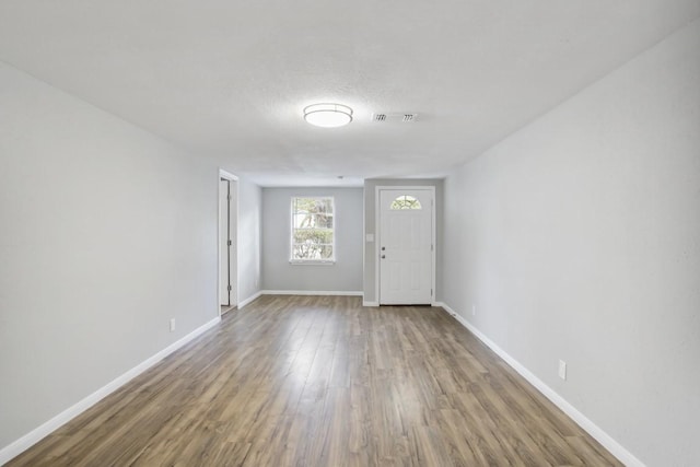 entryway featuring hardwood / wood-style floors and a textured ceiling