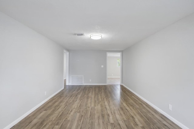 spare room with hardwood / wood-style floors