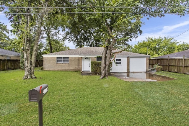 ranch-style home featuring a garage and a front lawn