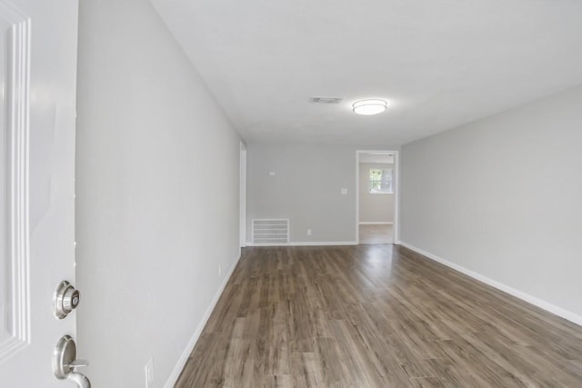 empty room featuring dark wood-type flooring