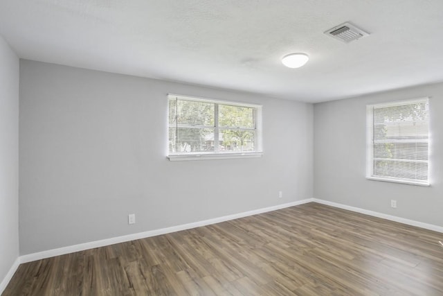 spare room with hardwood / wood-style floors