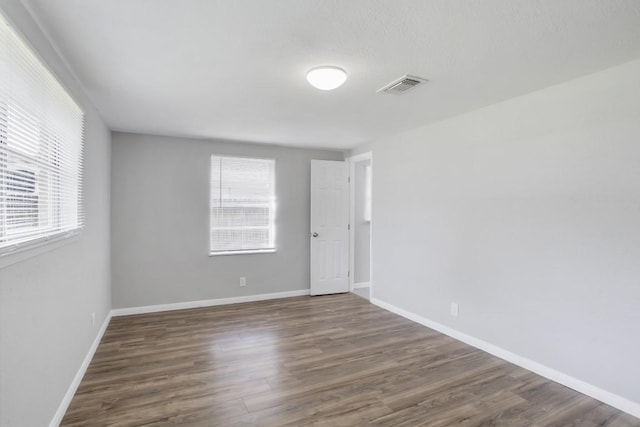 unfurnished room featuring dark hardwood / wood-style flooring