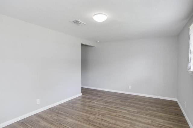 spare room with dark hardwood / wood-style flooring