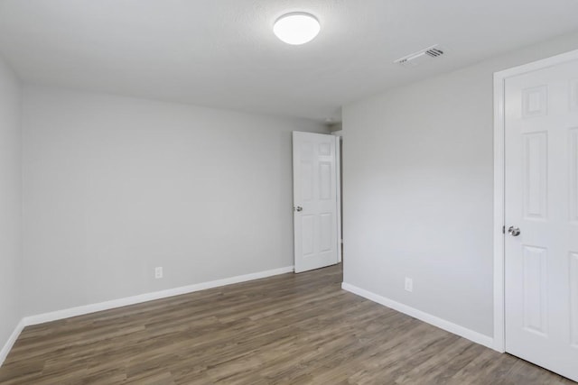 spare room featuring dark wood-type flooring