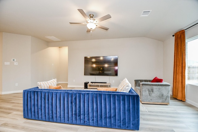 living room with ceiling fan, lofted ceiling, and light hardwood / wood-style floors