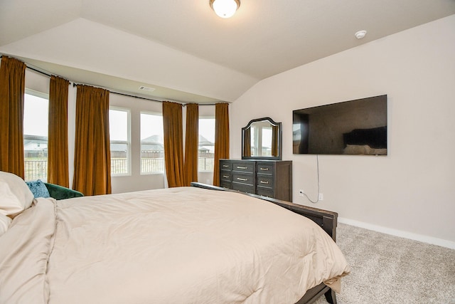 carpeted bedroom with lofted ceiling