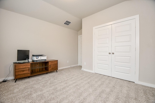 carpeted office with vaulted ceiling