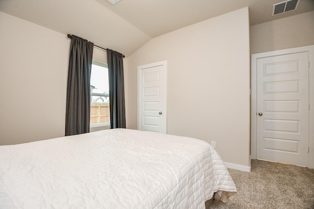 bedroom featuring vaulted ceiling and light carpet