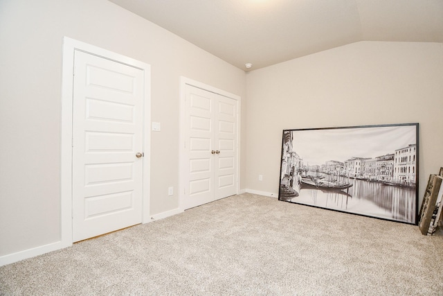 carpeted bedroom with vaulted ceiling