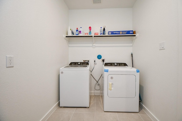 washroom featuring separate washer and dryer and light tile patterned flooring