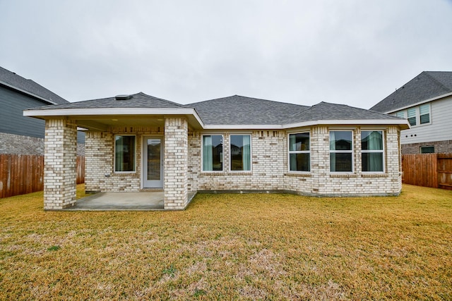 rear view of house with a yard and a patio area