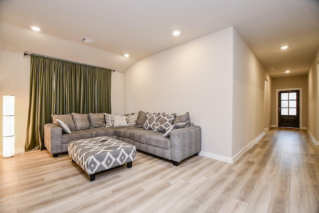 living room with lofted ceiling and light hardwood / wood-style flooring