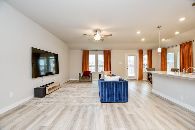 unfurnished living room featuring ceiling fan and light wood-type flooring