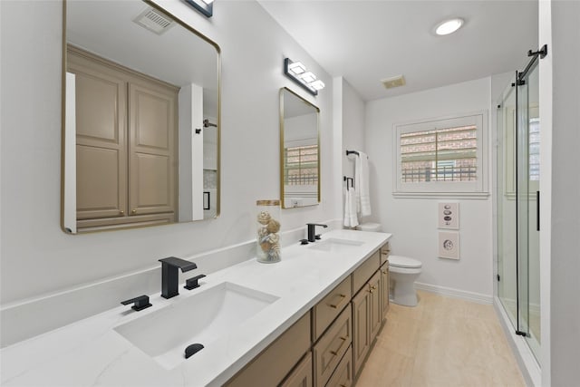 bathroom with vanity, walk in shower, and toilet