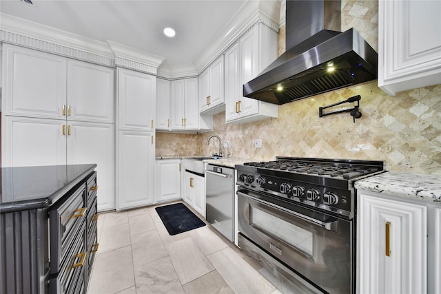 kitchen featuring white cabinetry, high end range, wall chimney exhaust hood, and stainless steel dishwasher