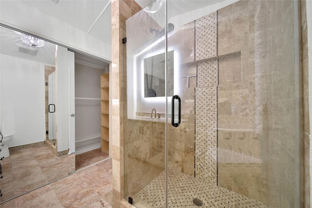 bathroom with toilet and an enclosed shower