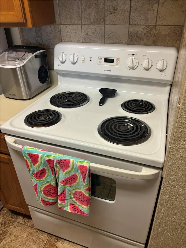 kitchen featuring light tile patterned flooring and electric stove