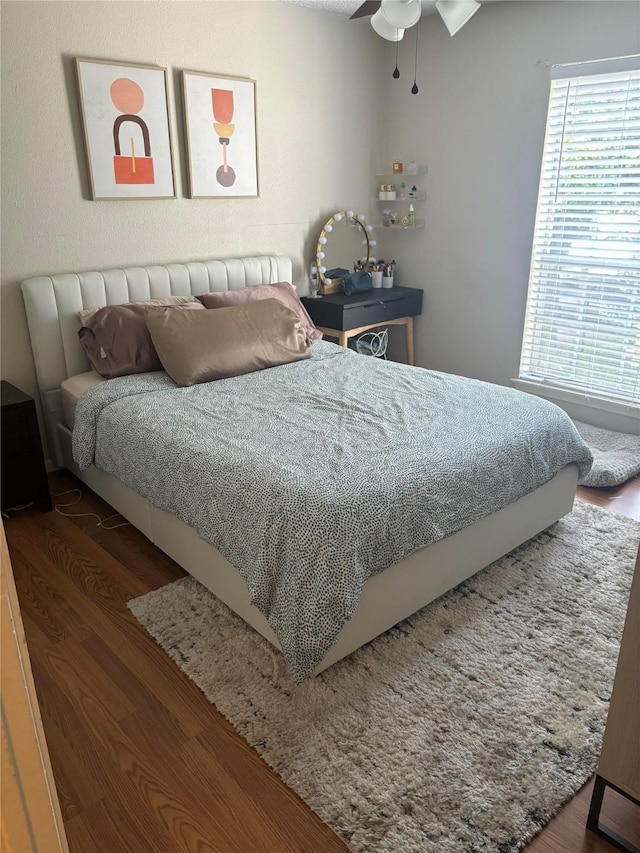 bedroom with ceiling fan and dark hardwood / wood-style floors