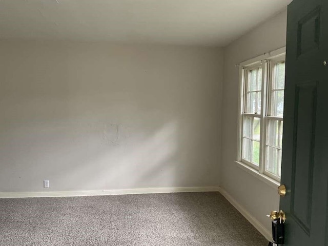 carpeted empty room with a healthy amount of sunlight