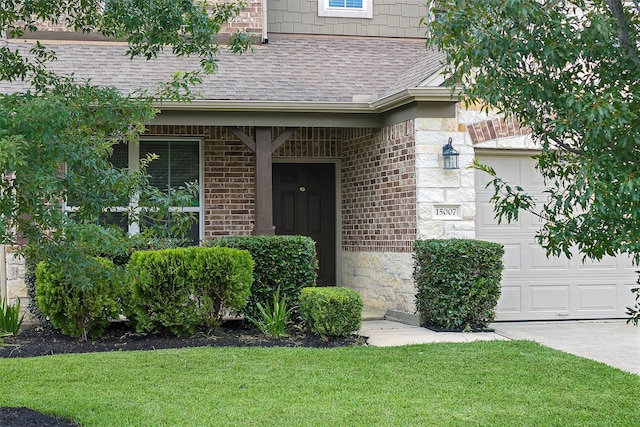 property entrance featuring a garage and a yard