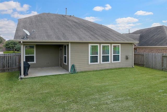 back of house featuring a yard and a patio area