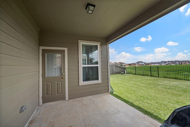 property entrance with a patio and a yard