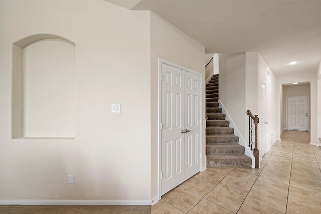 stairway with tile patterned floors