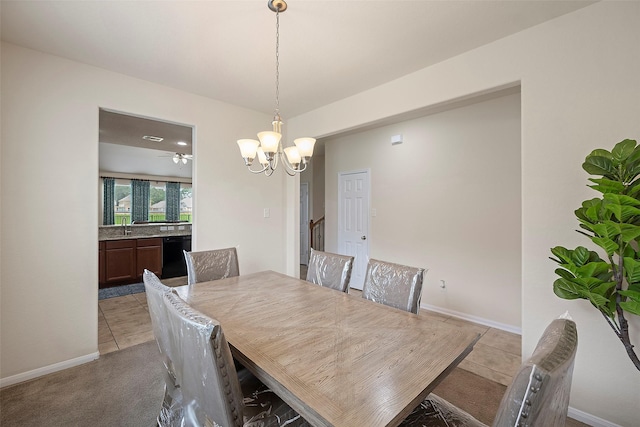 dining space with sink, light tile patterned floors, and a notable chandelier