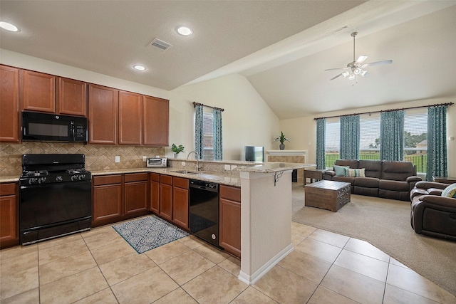 kitchen with lofted ceiling, sink, tasteful backsplash, kitchen peninsula, and black appliances