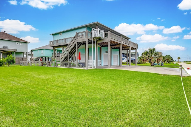 back of house with a garage, a wooden deck, and a lawn