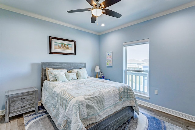 bedroom featuring hardwood / wood-style flooring, ornamental molding, and ceiling fan